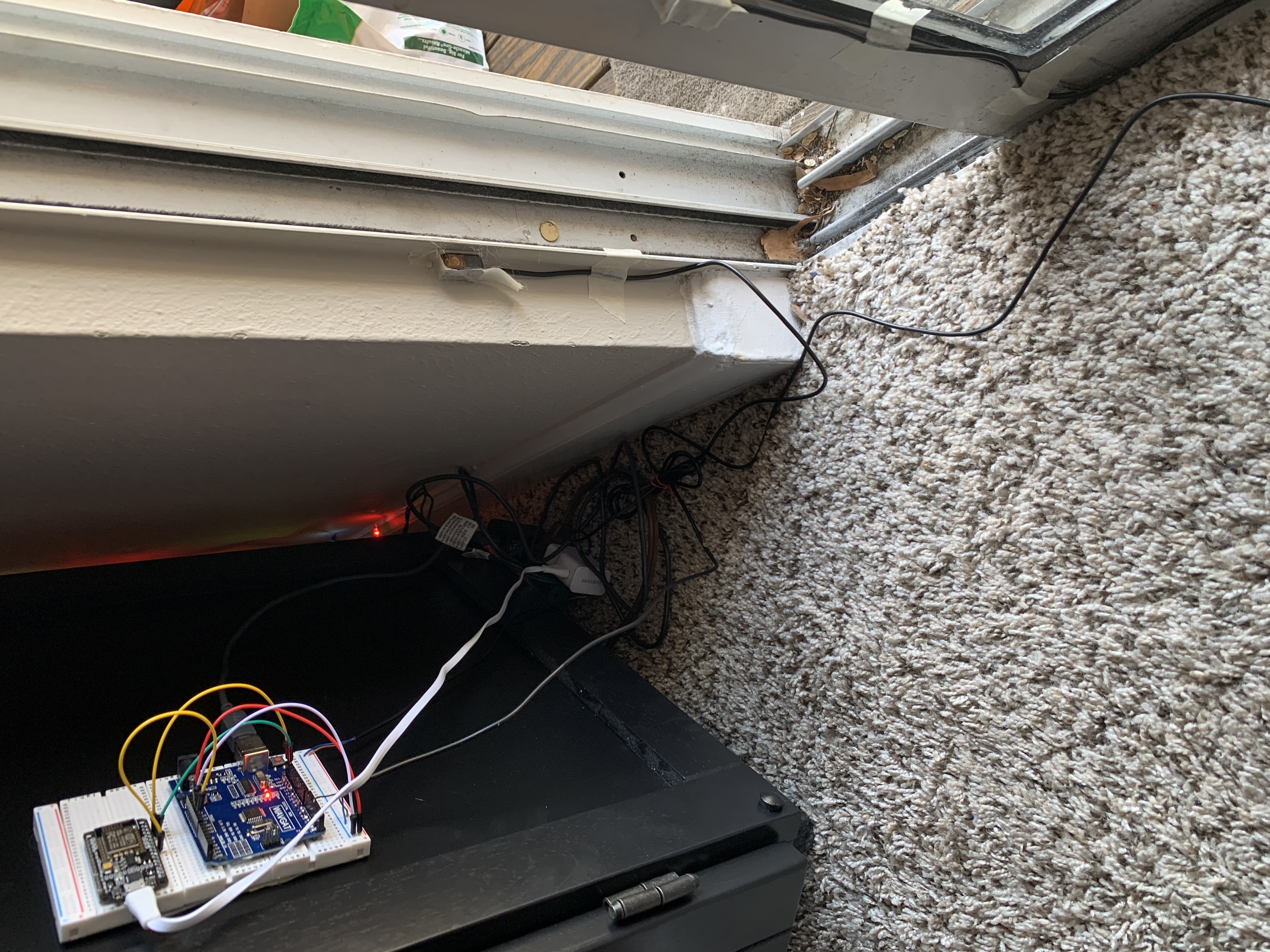 Full view of ir beam sensors on the right and bread boards with the arduino uno and esp8266